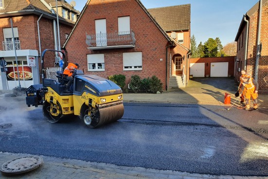 Bevor der Asphalt zu kalt wird, muss gewalzt werden. 